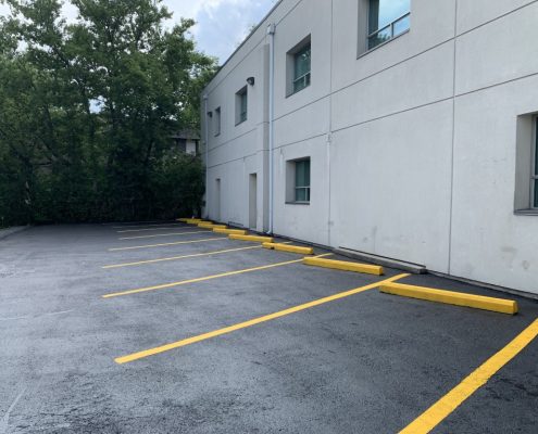 Image depicts a parking lot with newly painted parking lines.