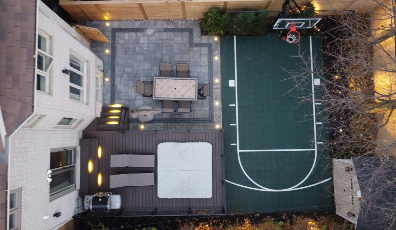 Image depicts a backyard with basketball court