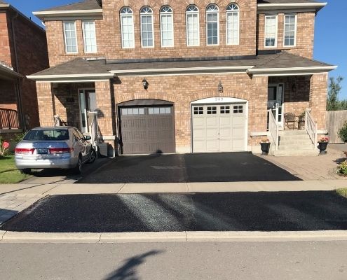 Driveway with asphalt sealcoating installed.