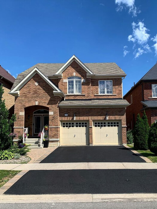 A 2-storey detached home in Toronto with a freshly sealed driveway by Action Home Services