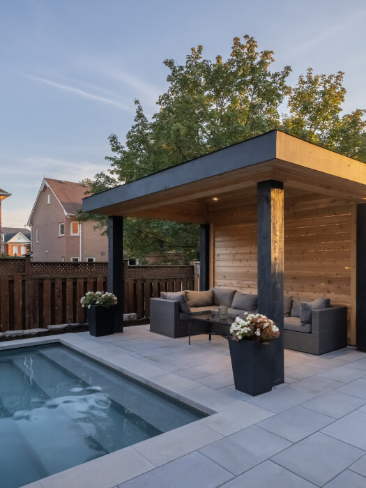 Interlocking stone by the pool with a wood pergola canopy in a Toronto backyard
