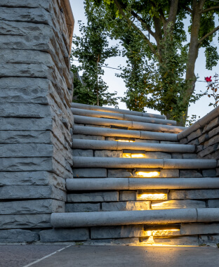 A set of interlocked stone steps with lighting in a Toronto backyard