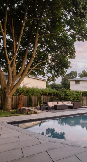 Backyard patio with interlocking stone by the pool in Toronto