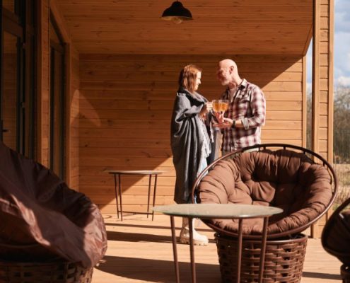 Older couple standing in a custom wooden veranda