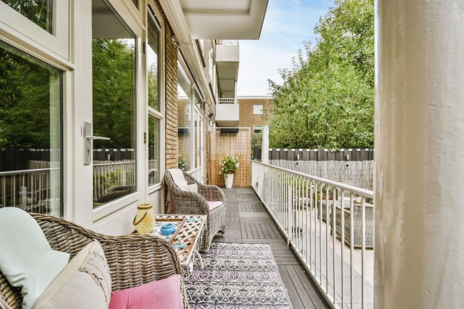 Narrow veranda with wicker furniture