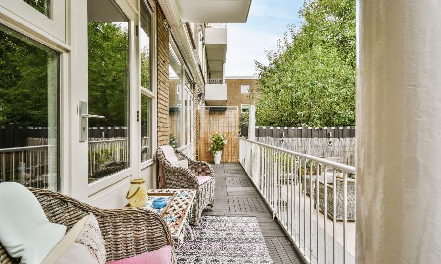 Narrow veranda with wicker furniture