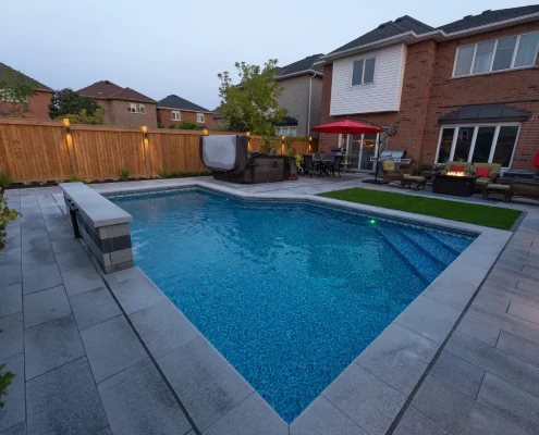 backyard pool and hot tub installation with flowers