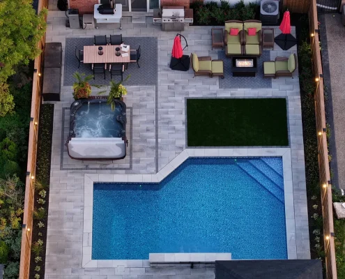 pool waterfall feature with hot tub and fireplace